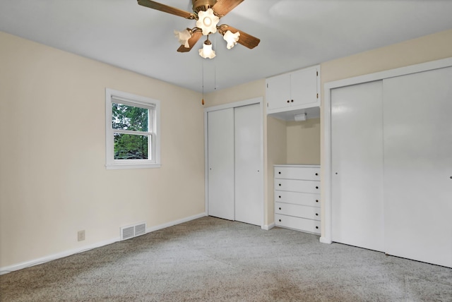 1217 High St, Lake City, MN 55041 - unfurnished bedroom featuring two closets, carpet floors, baseboards, and ceiling fan