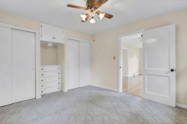 1217 High St, Lake City, MN 55041 - unfurnished bedroom with two closets, carpet floors, baseboards, and a ceiling fan
