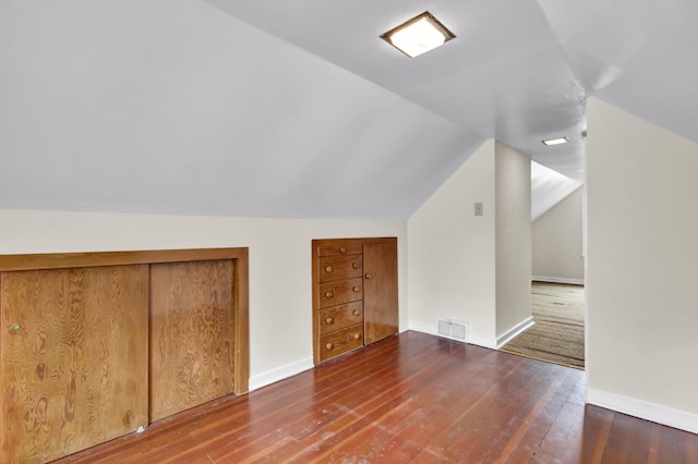 1217 High St, Lake City, MN 55041 - additional living space with hardwood / wood-style floors, vaulted ceiling, and baseboards