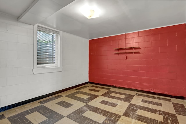 1217 High St, Lake City, MN 55041 - empty room with tile patterned floors and concrete block wall