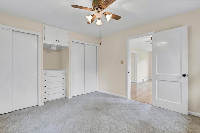 1217 High St, Lake City, MN 55041 - unfurnished bedroom featuring multiple closets, carpet flooring, and a ceiling fan