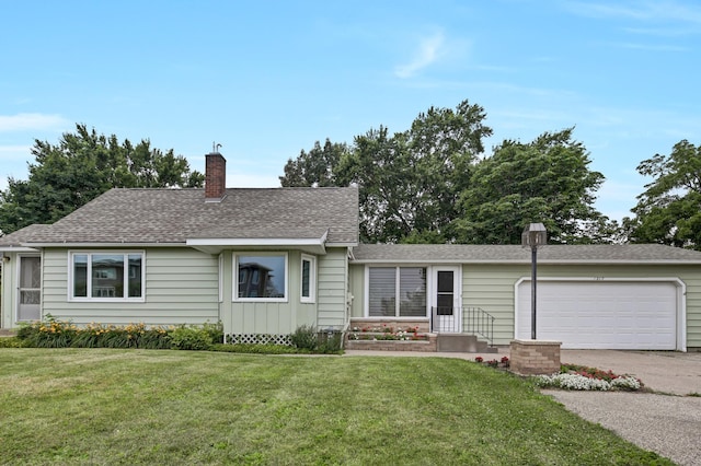 1217 High St, Lake City, MN 55041 - single story home featuring a chimney, an attached garage, a front lawn, and roof with shingles