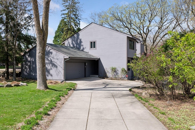 view of property exterior with a lawn, concrete driveway, and a garage