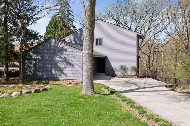 view of side of property with fence and a yard