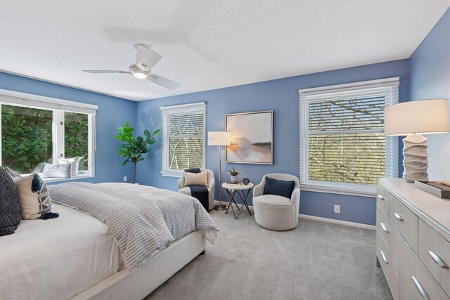 bedroom featuring baseboards, ceiling fan, and carpet