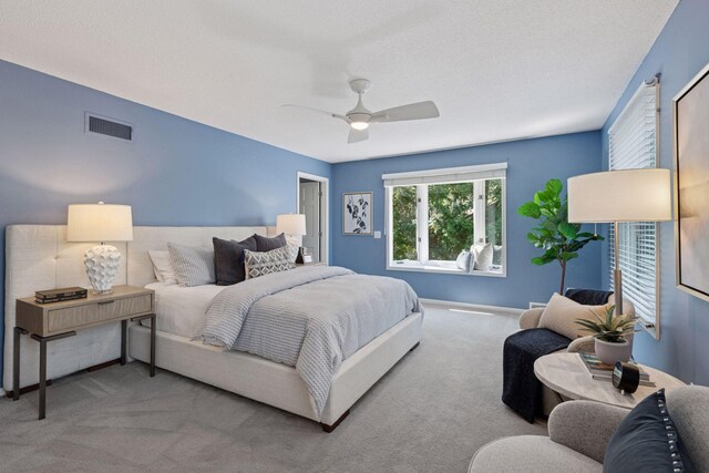 bedroom featuring carpet floors, ceiling fan, and visible vents