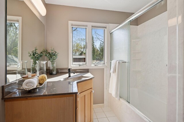 bathroom with vanity, bath / shower combo with glass door, and tile patterned floors
