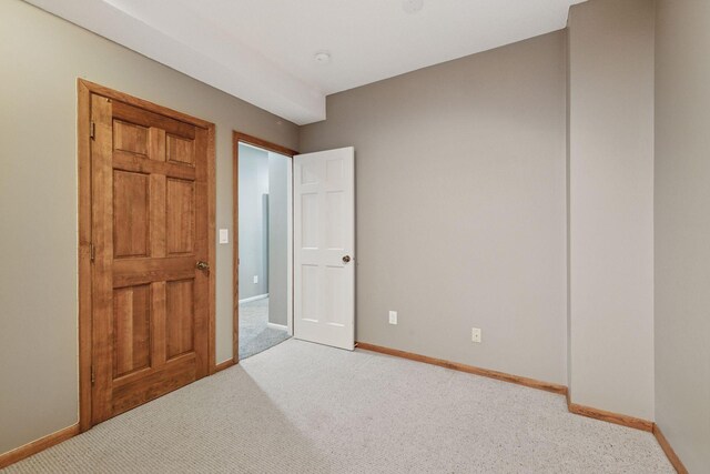 unfurnished bedroom with baseboards and carpet flooring
