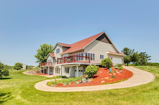 rear view of house with a lawn and a wooden deck