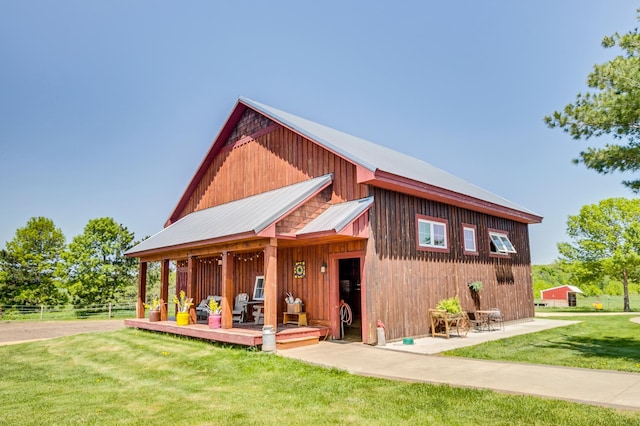 view of front of property with a front lawn, fence, and metal roof