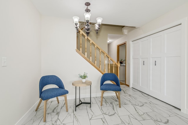 living area with baseboards, marble finish floor, stairs, and a chandelier