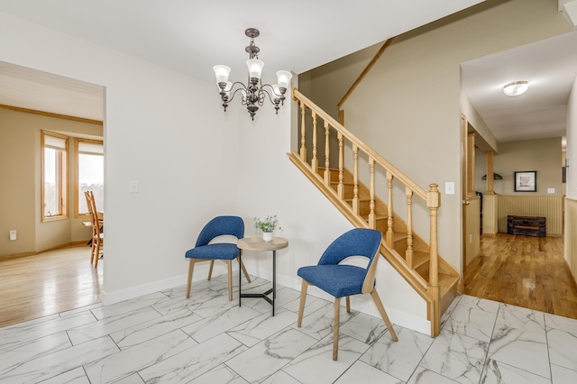 interior space with stairway, baseboards, an inviting chandelier, and marble finish floor