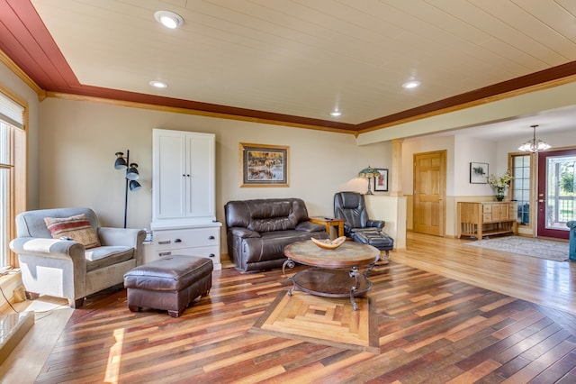 living area featuring crown molding, an inviting chandelier, recessed lighting, and light wood-style flooring