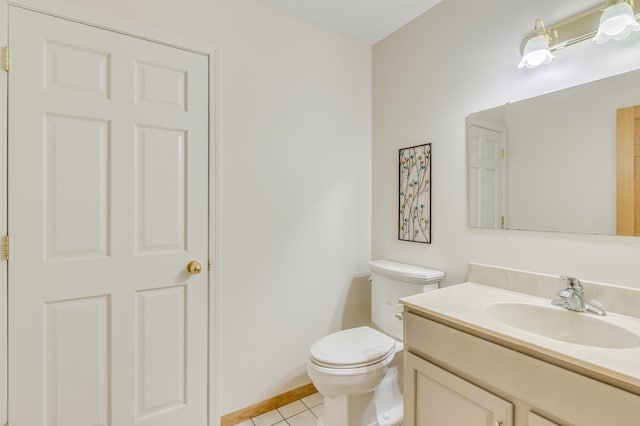 bathroom featuring vanity, tile patterned floors, and toilet