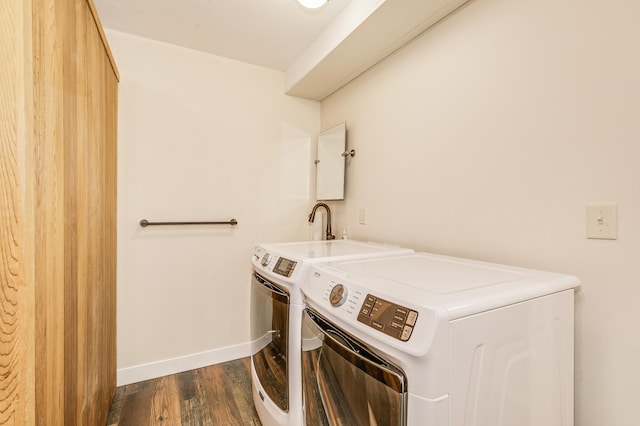 laundry room featuring laundry area, dark wood finished floors, baseboards, and washer and dryer