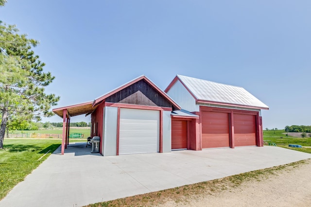 garage featuring concrete driveway