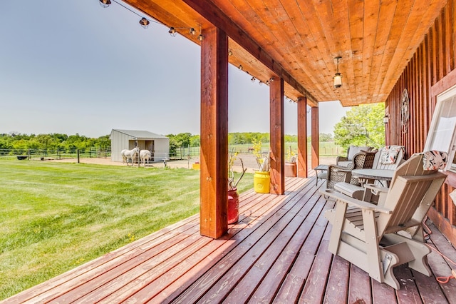 wooden terrace with an outdoor structure and a yard