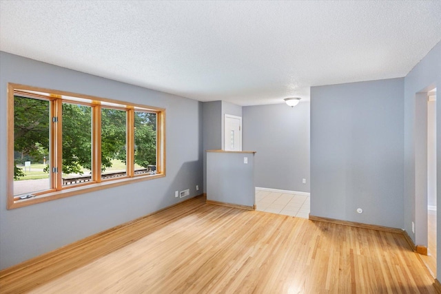 7872 142nd St W, Apple Valley, MN 55124 - empty room with wood finished floors and a textured ceiling