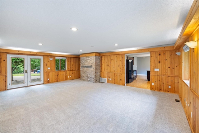 7872 142nd St W, Apple Valley, MN 55124 - unfurnished living room featuring wood walls, light carpet, and recessed lighting