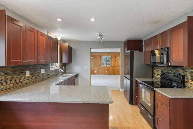 7872 142nd St W, Apple Valley, MN 55124 - kitchen with black appliances, a textured ceiling, light wood-type flooring, decorative backsplash, and a peninsula