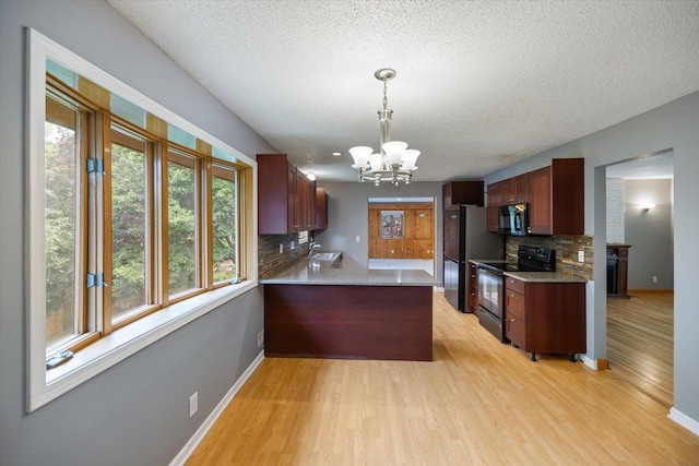 7872 142nd St W, Apple Valley, MN 55124 - kitchen with black appliances, a chandelier, a textured ceiling, plenty of natural light, and decorative backsplash