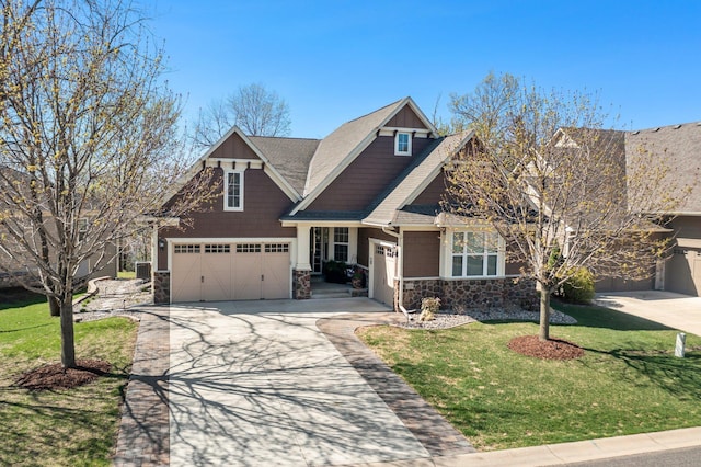 5435 Yellowstone Trl, Minnetrista, MN 55331 - craftsman-style home with stone siding, concrete driveway, an attached garage, a front yard, and roof with shingles