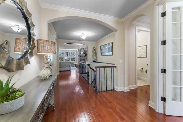 5435 Yellowstone Trl, Minnetrista, MN 55331 - hall with arched walkways, wood-type flooring, an upstairs landing, crown molding, and baseboards