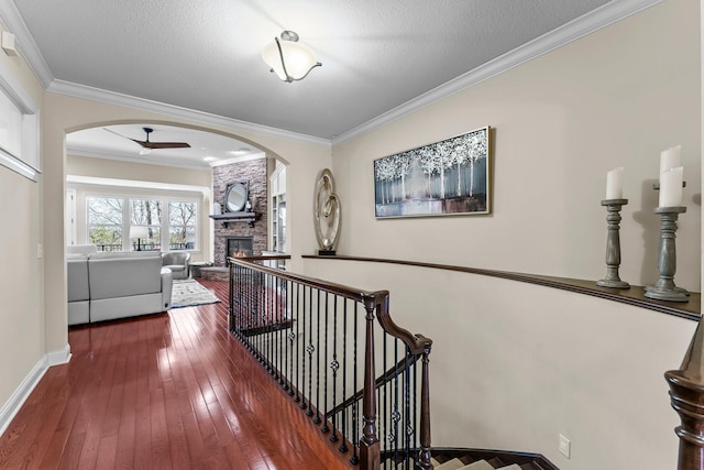 5435 Yellowstone Trl, Minnetrista, MN 55331 - hallway with arched walkways, dark wood-type flooring, ornamental molding, and baseboards