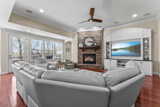 5435 Yellowstone Trl, Minnetrista, MN 55331 - living room featuring ornamental molding, a ceiling fan, dark wood-type flooring, a fireplace, and baseboards