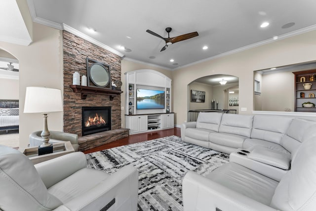 5435 Yellowstone Trl, Minnetrista, MN 55331 - living area featuring arched walkways, a ceiling fan, ornamental molding, wood finished floors, and a fireplace