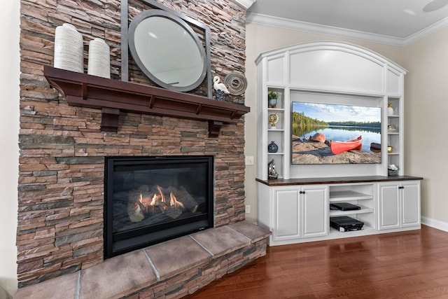 5435 Yellowstone Trl, Minnetrista, MN 55331 - unfurnished living room with dark wood-style flooring, ornamental molding, and a stone fireplace