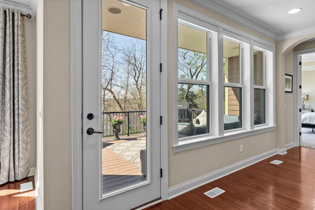 5435 Yellowstone Trl, Minnetrista, MN 55331 - doorway to outside featuring wood finished floors, arched walkways, baseboards, crown molding, and recessed lighting