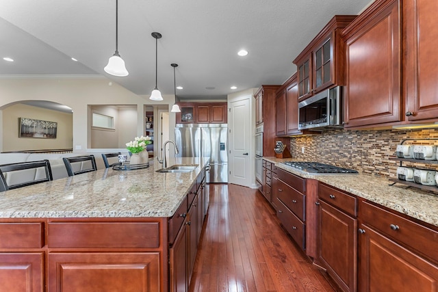 5435 Yellowstone Trl, Minnetrista, MN 55331 - kitchen with a sink, appliances with stainless steel finishes, glass insert cabinets, light stone countertops, and backsplash