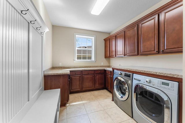 5435 Yellowstone Trl, Minnetrista, MN 55331 - laundry room with cabinet space, washer and dryer, and light tile patterned floors