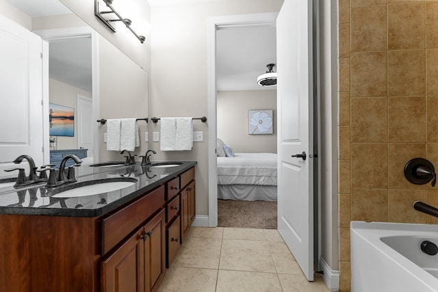 5435 Yellowstone Trl, Minnetrista, MN 55331 - ensuite bathroom with tile patterned floors, double vanity, baseboards, and shower / washtub combination