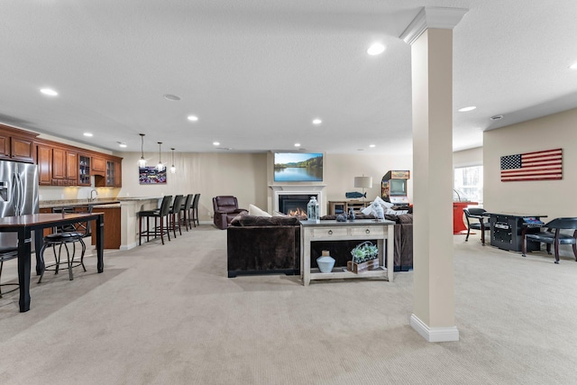 5435 Yellowstone Trl, Minnetrista, MN 55331 - living room featuring light carpet, recessed lighting, a lit fireplace, and baseboards