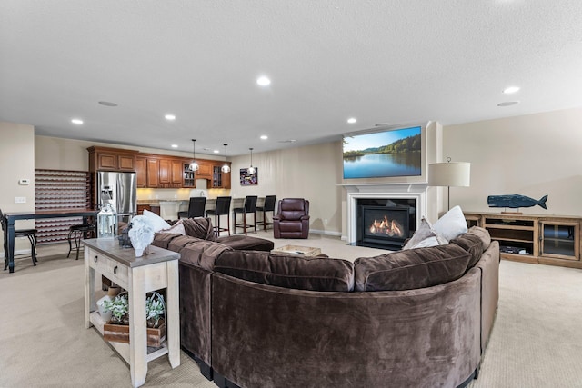 5435 Yellowstone Trl, Minnetrista, MN 55331 - living room featuring light colored carpet, recessed lighting, a fireplace with flush hearth, and a textured ceiling