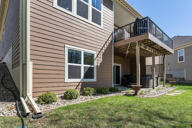 5435 Yellowstone Trl, Minnetrista, MN 55331 - rear view of property featuring a yard, a wooden deck, a hot tub, and central AC
