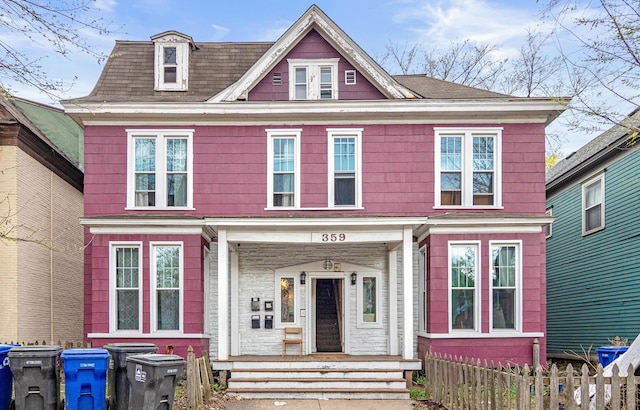 view of front of property with covered porch and fence