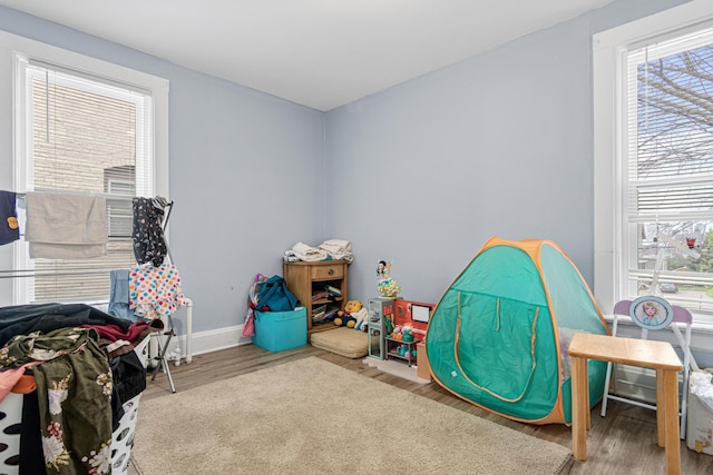 rec room featuring baseboards and wood finished floors