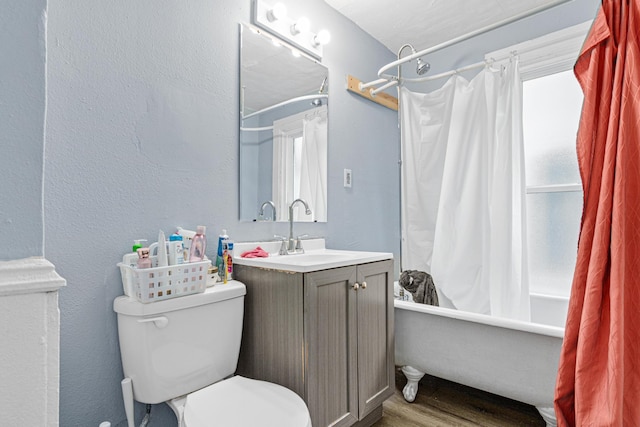 full bathroom featuring vanity, toilet, shower / bathtub combination with curtain, and wood finished floors