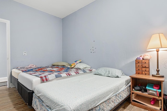 bedroom with wood finished floors