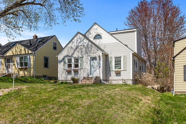 view of front of house with entry steps and a front lawn