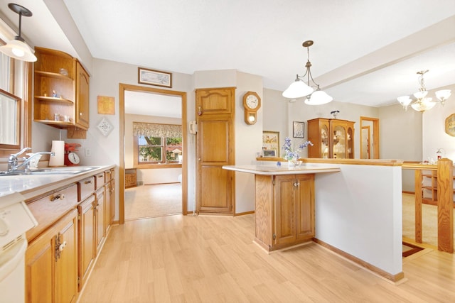 517 2nd St, Waconia, MN 55387 - kitchen with light wood-type flooring, light countertops, range, and pendant lighting