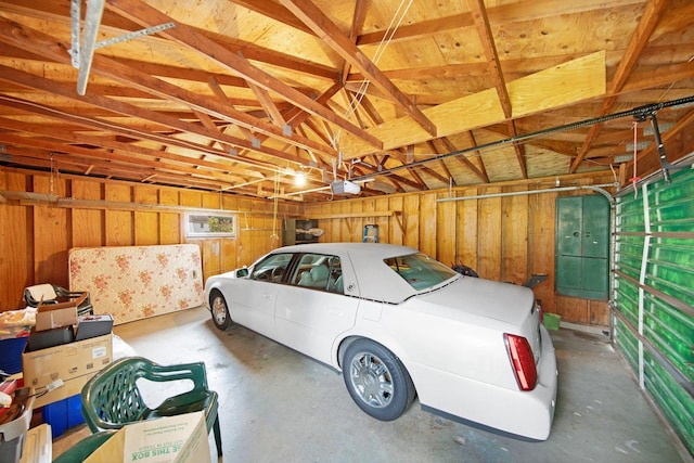 517 2nd St, Waconia, MN 55387 - garage featuring a garage door opener and wooden walls