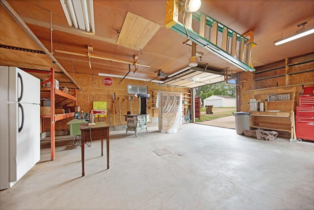517 2nd St, Waconia, MN 55387 - garage with freestanding refrigerator and a workshop area