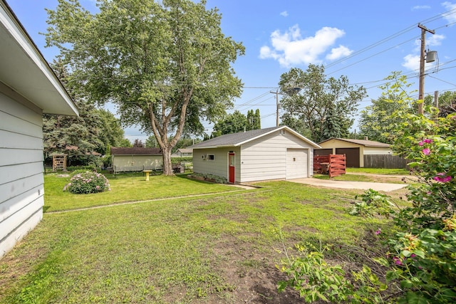517 2nd St, Waconia, MN 55387 - view of yard featuring an outdoor structure, a garage, and concrete driveway