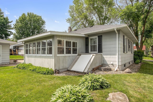 517 2nd St, Waconia, MN 55387 - rear view of house featuring a yard and a chimney