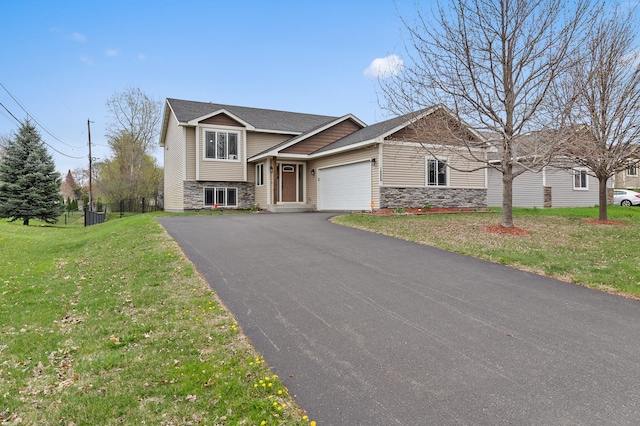 1226 1st St, Saint Paul Park, MN 55071 - tri-level home featuring fence, an attached garage, a front lawn, stone siding, and driveway