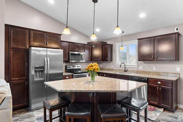 1226 1st St, Saint Paul Park, MN 55071 - kitchen with dark brown cabinetry, a kitchen bar, a sink, lofted ceiling, and stainless steel appliances